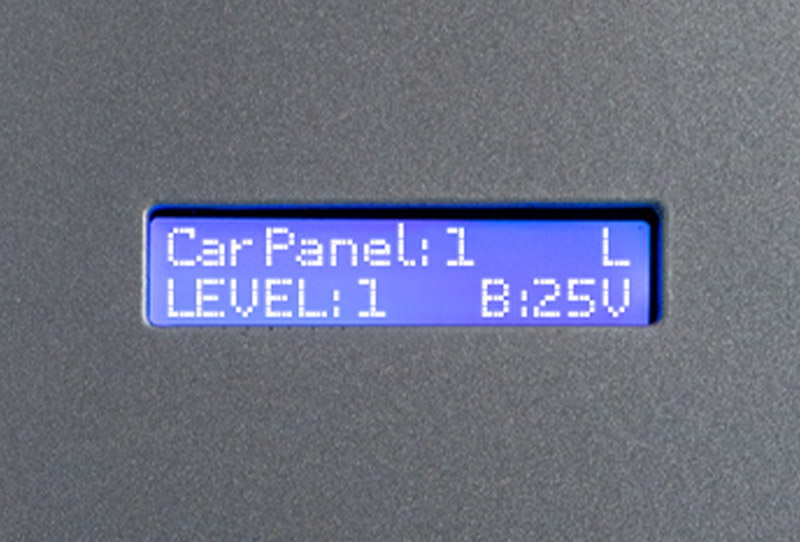 Close up shot of LCD status display on Savaria Luma through-floor lift that reads 'Car Panel: 1, Level: 1, B:25V'